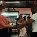 West Coast Swing dancers demonstrating a Left Side Pass and Right-Side Pass on the dance floor