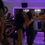 West Coast Swing partners practicing a basic step on the social dance floor.